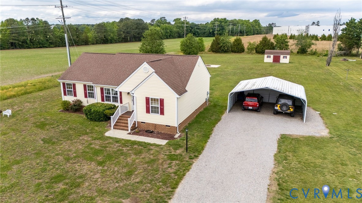 5280 West Quaker Road Disputanta, VA 23875 - Photo 10 of 33 an aerial view of a house with swimming pool garden and tall trees