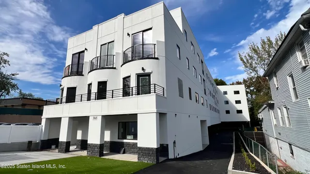 a large building with a lot of windows and plants