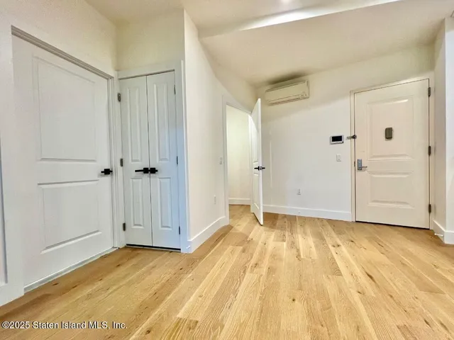 a view of a room with wooden floor