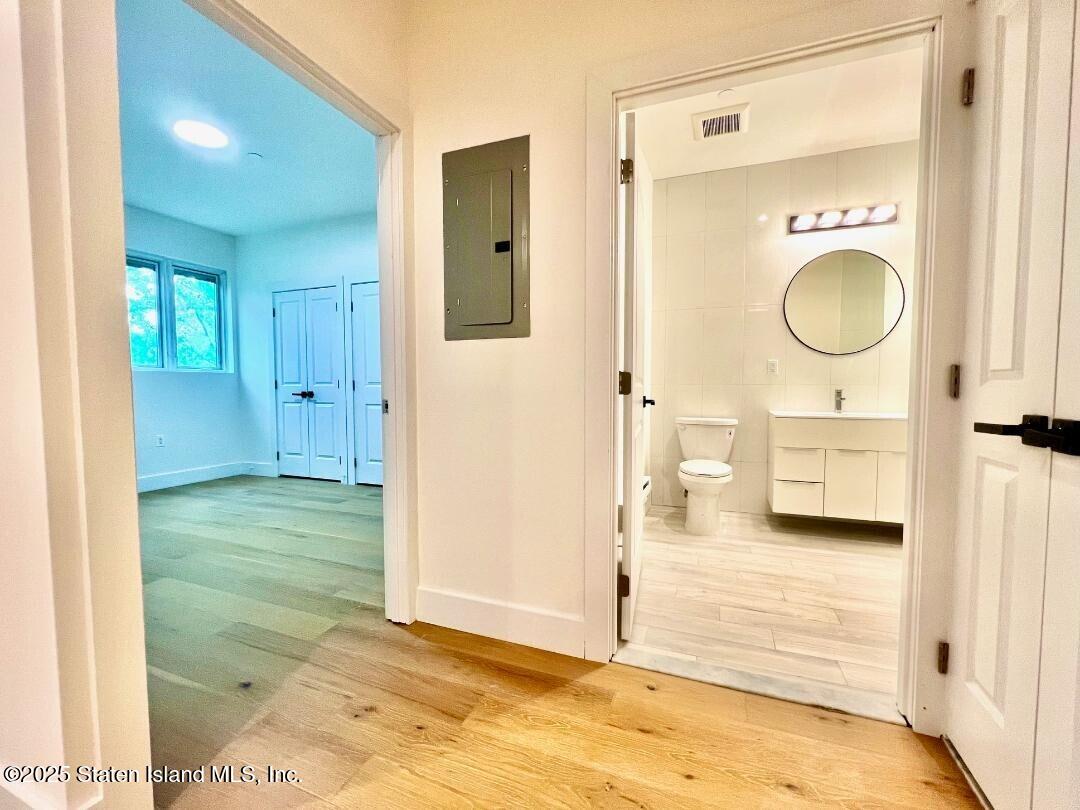 3865 Amboy Road, Unit 3F Staten Island, NY 10308 - Photo 12 of 20 a bathroom with a sink a toilet and shower