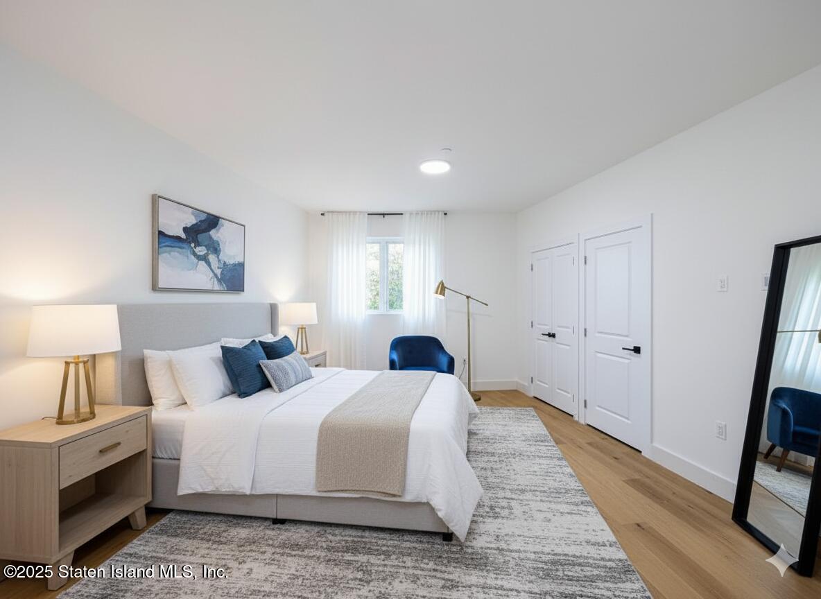 3865 Amboy Road, Unit 3F Staten Island, NY 10308 - Photo 17 of 20 a bedroom with a bed and a large mirror on dresser