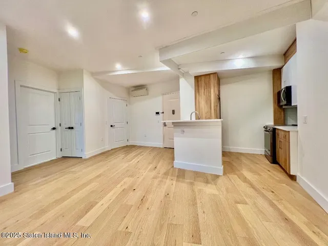 a view of kitchen with cabinets and wooden floor