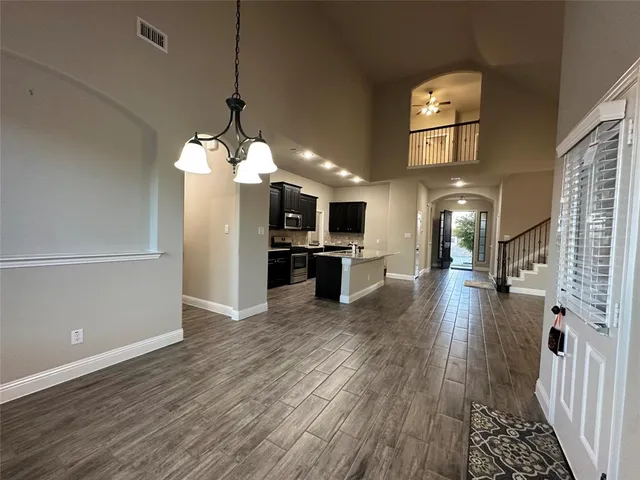 a view of a kitchen with cabinets and wooden floor