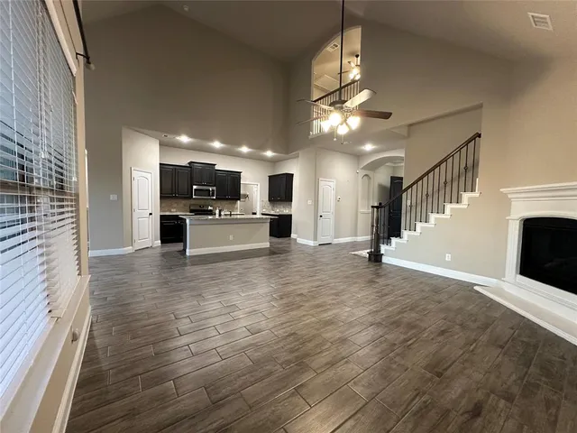 a view of a livingroom with wooden floor and a ceiling fan