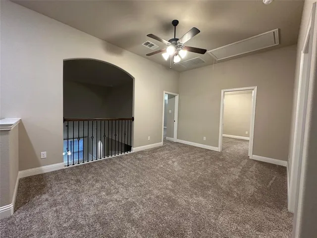 a view of a livingroom with a ceiling fan and closet area