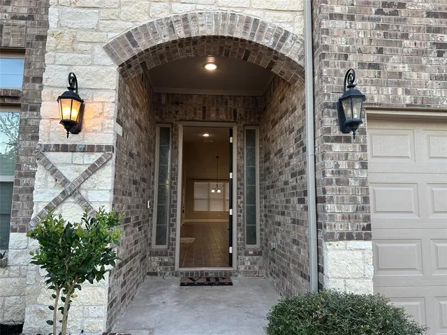 a couple of potted plants in front of door
