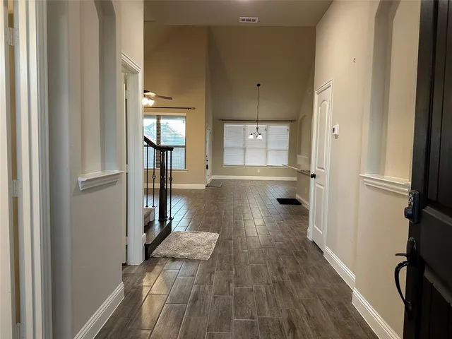 a view of a hallway view with wooden floor and staircase