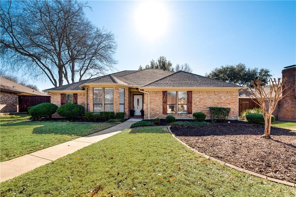 a front view of a house with yard patio and green space