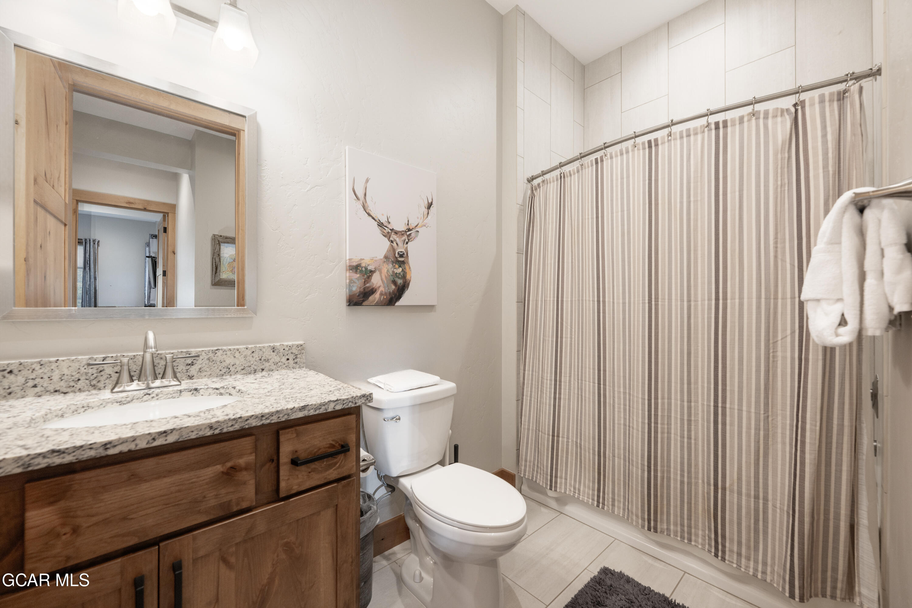 40 Springview Lane Fraser, CO 80442 - Photo 11 of 36 a bathroom with a granite countertop toilet sink and mirror