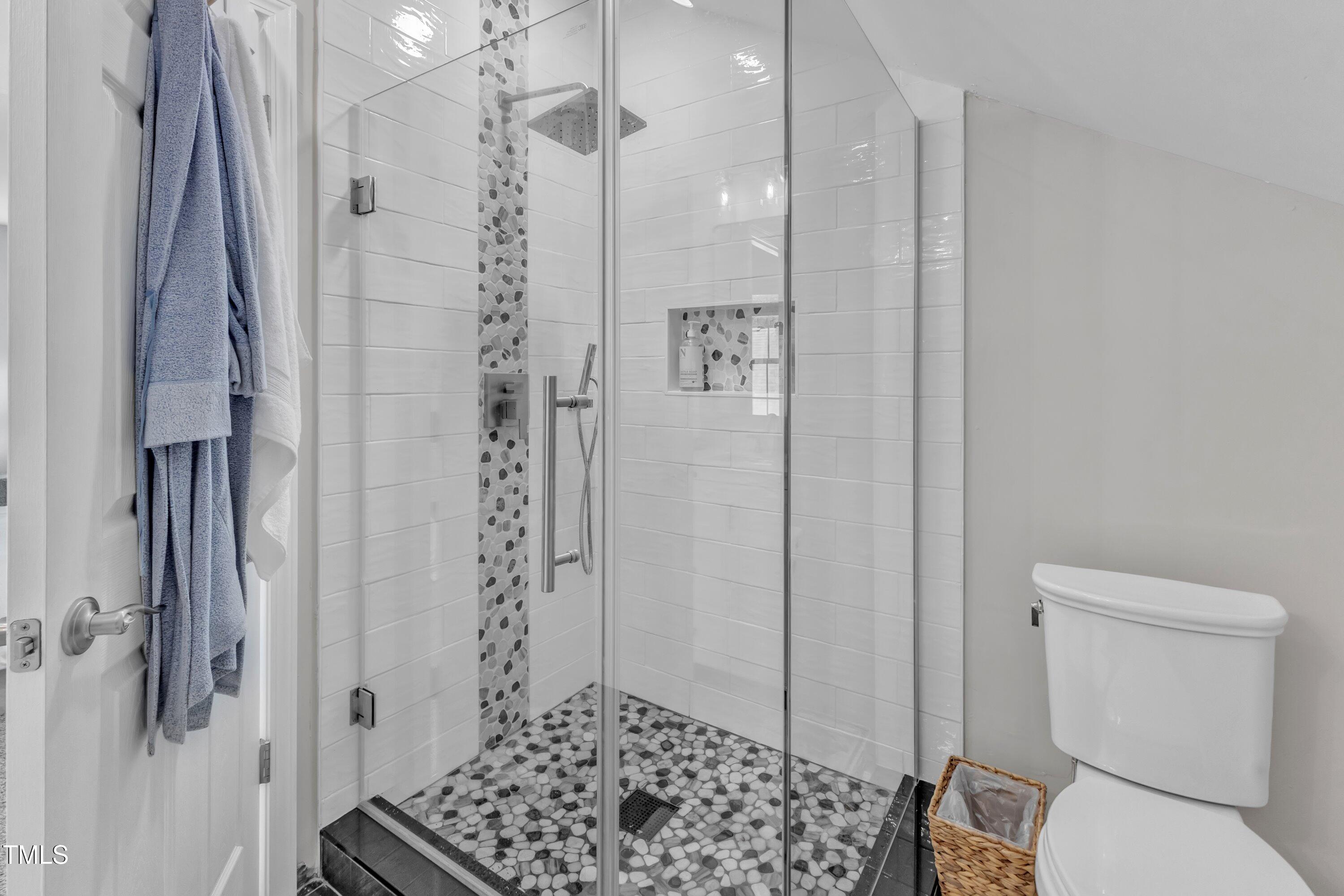 3119 Guiding Light Road Raleigh, NC 27610 - Photo 51 of 60 a bathroom with a shower a toilet and a sink