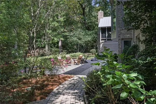 a front view of a house with a yard and fountain