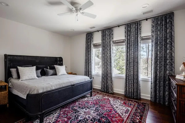a bedroom with a large bed and a window