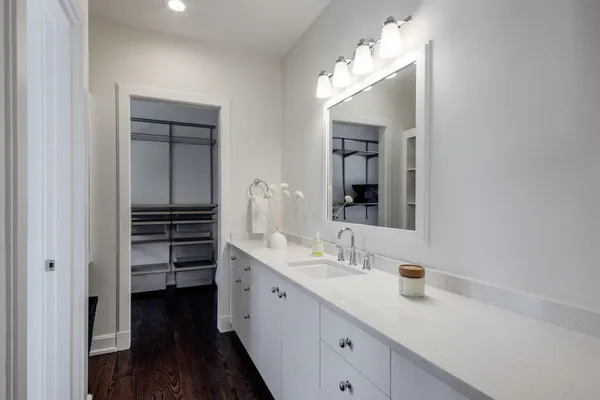 a bathroom with a sink a vanity and a mirror