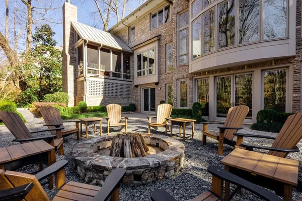 a view of a patio with couches table and chairs and potted plants