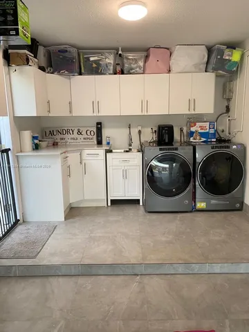 a kitchen with a stove cabinets and a sink