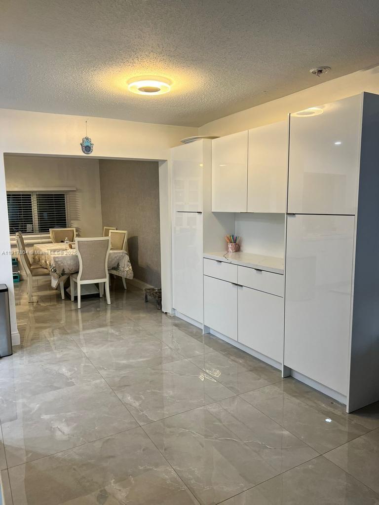 7303 Northwest 57th Drive, Unit 7303 Tamarac, FL 33321 - Photo 8 of 15 a view of a kitchen with a sink and cabinets