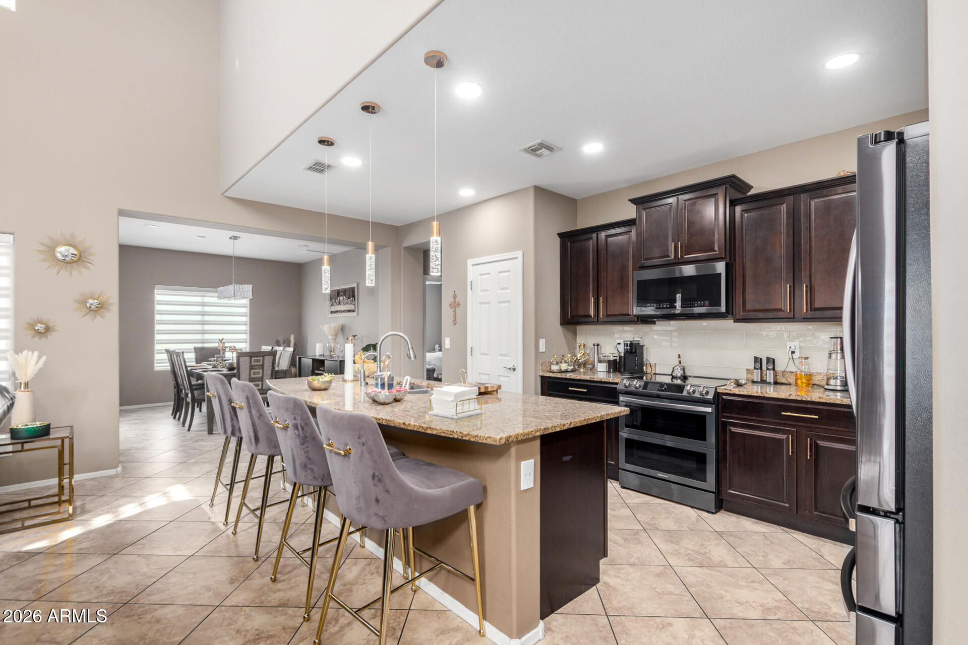 10816 West Nosean Road Peoria, AZ 85383 - Photo 13 of 42 a view of kitchen with sink dining table and chairs