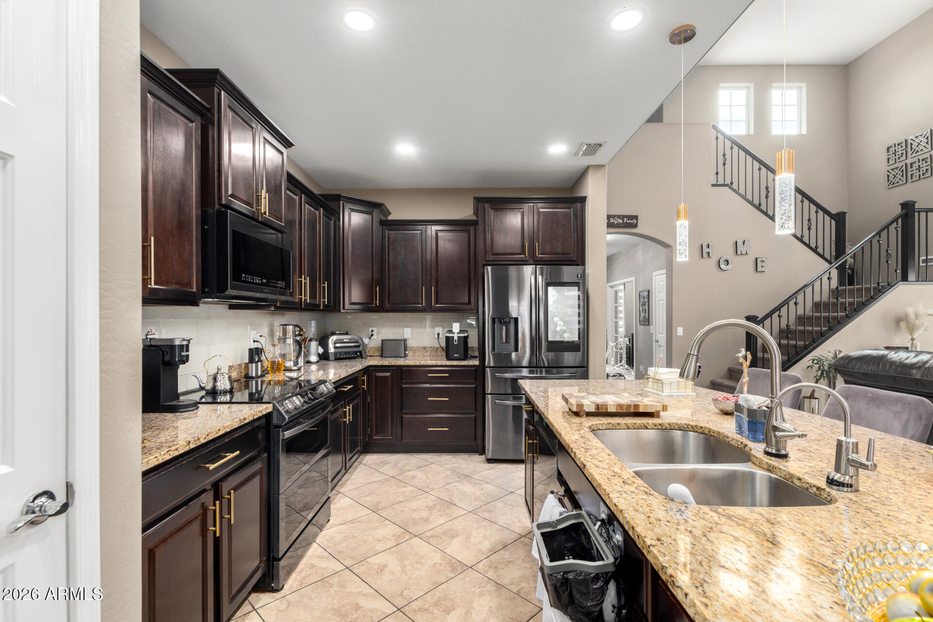 10816 West Nosean Road Peoria, AZ 85383 - Photo 14 of 42 a kitchen with granite countertop a sink stainless steel appliances and cabinets