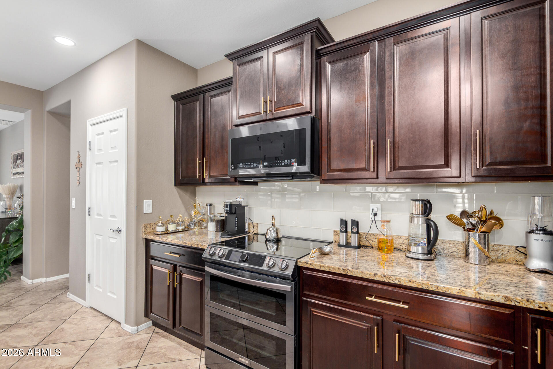 10816 West Nosean Road Peoria, AZ 85383 - Photo 15 of 42 a kitchen with granite countertop stainless steel appliances and sink
