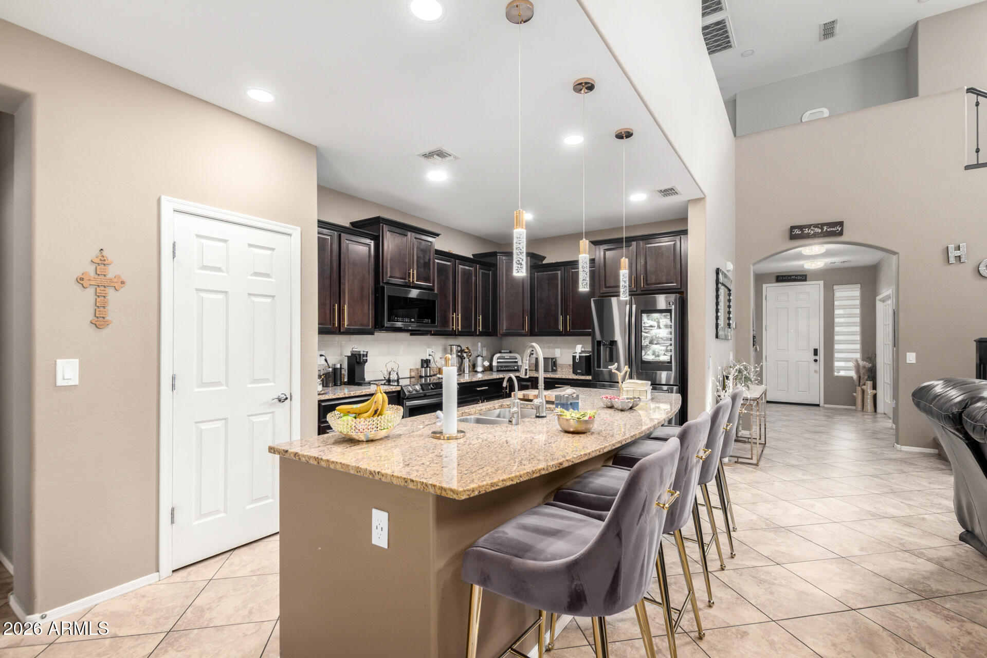 10816 West Nosean Road Peoria, AZ 85383 - Photo 16 of 42 a kitchen with a sink a stove and chairs