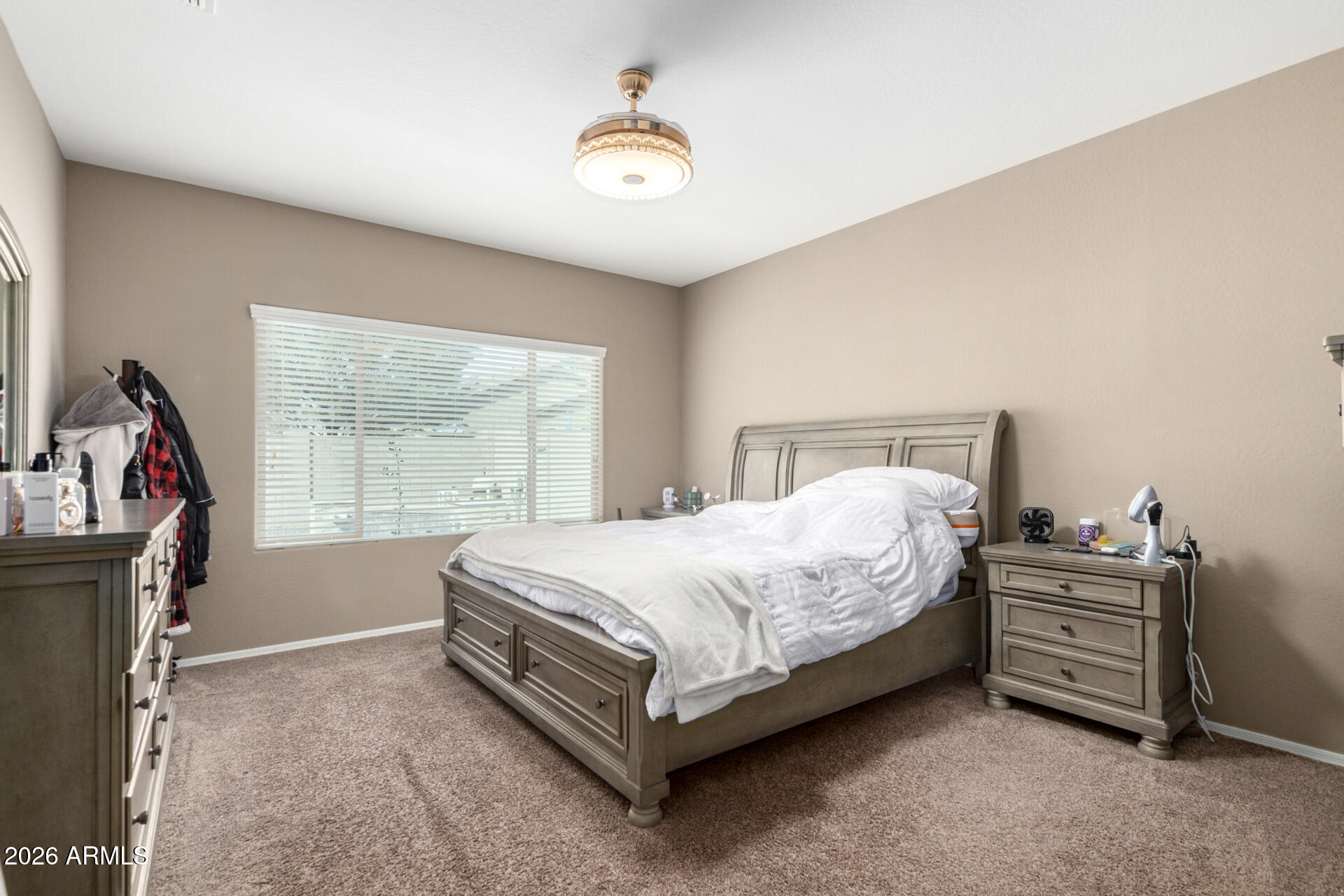 10816 West Nosean Road Peoria, AZ 85383 - Photo 17 of 42 a bed sitting in a room next to a window