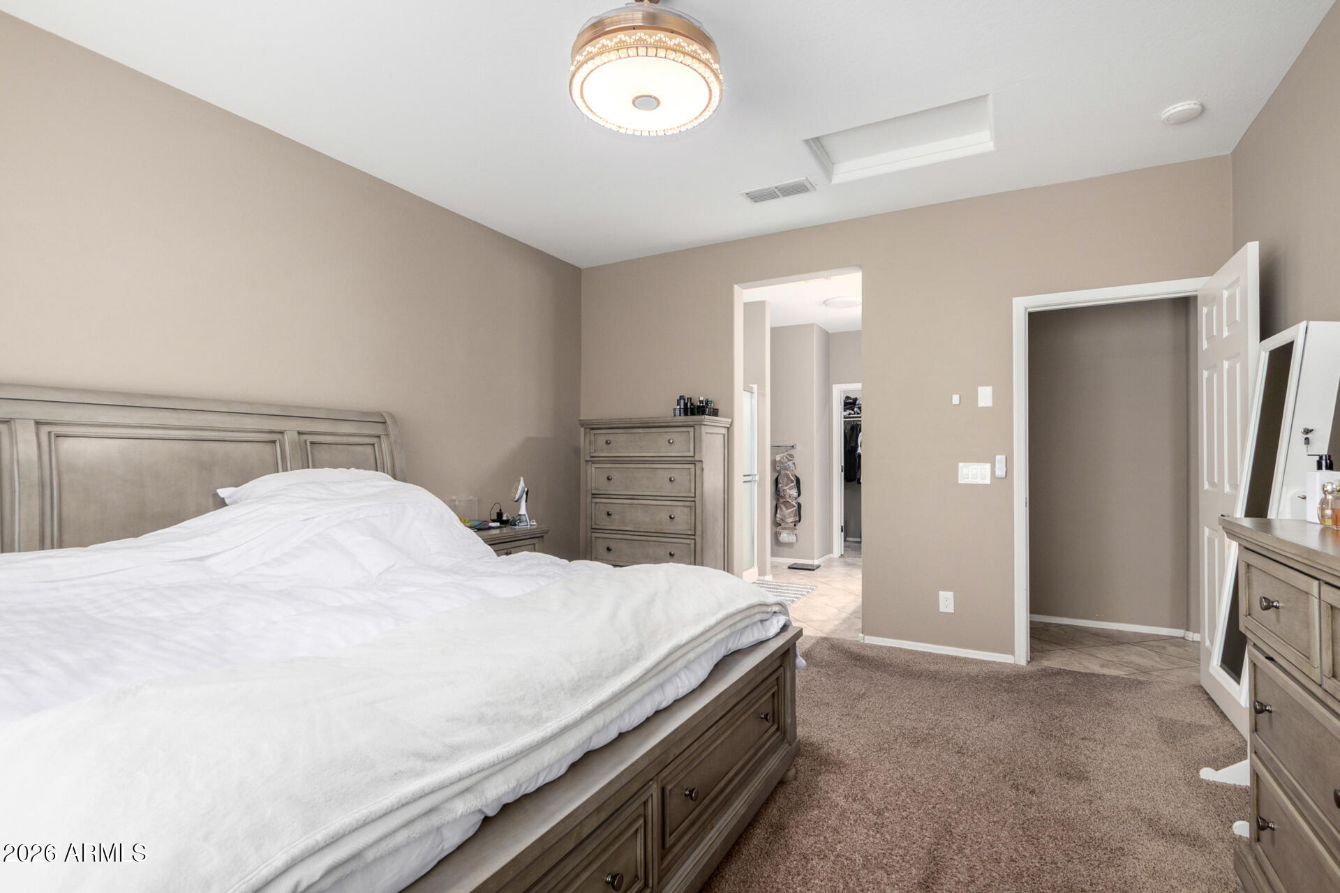 10816 West Nosean Road Peoria, AZ 85383 - Photo 18 of 42 a bedroom with a bed and a chandelier
