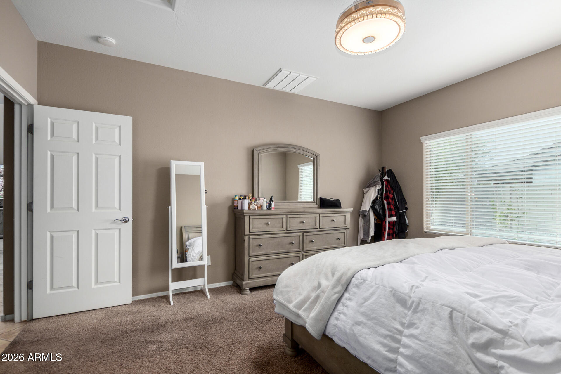 10816 West Nosean Road Peoria, AZ 85383 - Photo 19 of 42 a bedroom with a bed and a large window