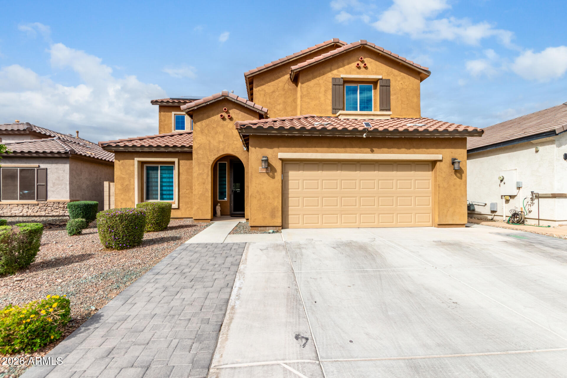 10816 West Nosean Road Peoria, AZ 85383 - Photo 2 of 42 a front view of a house with a yard and garage