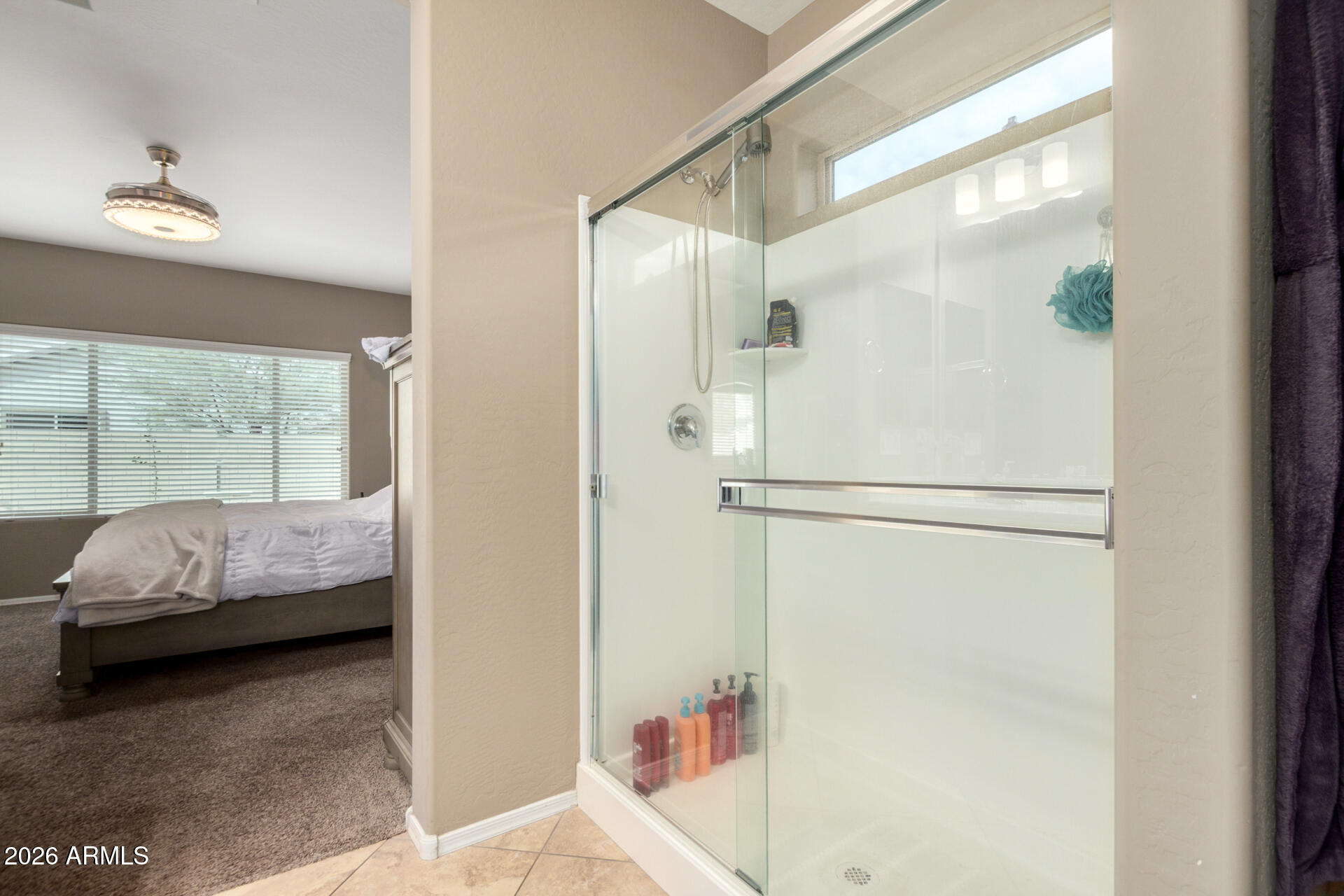 10816 West Nosean Road Peoria, AZ 85383 - Photo 21 of 42 a en suite bathroom with a tub and a large window