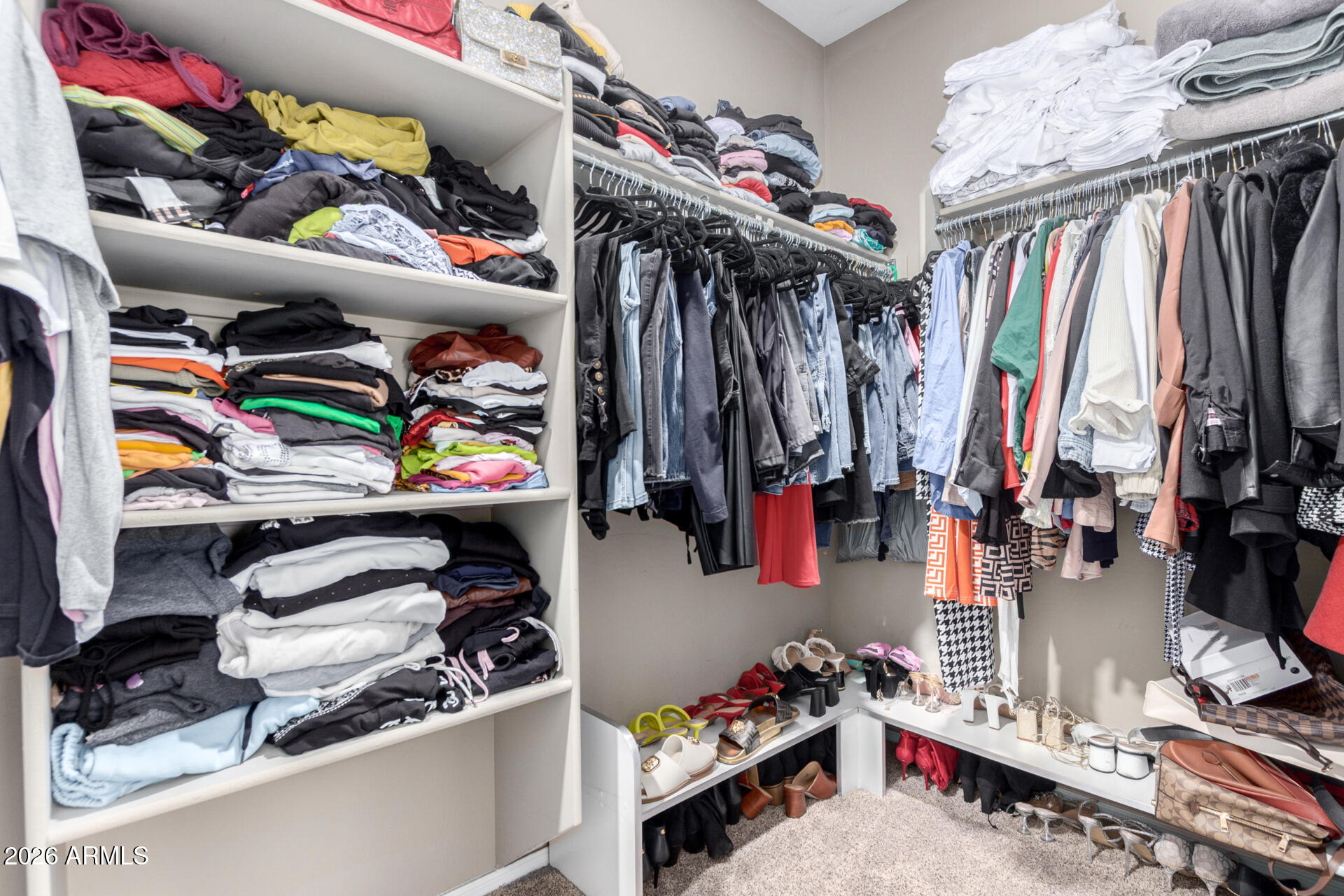 10816 West Nosean Road Peoria, AZ 85383 - Photo 22 of 42 a view of walk in closet with clothes and shoes