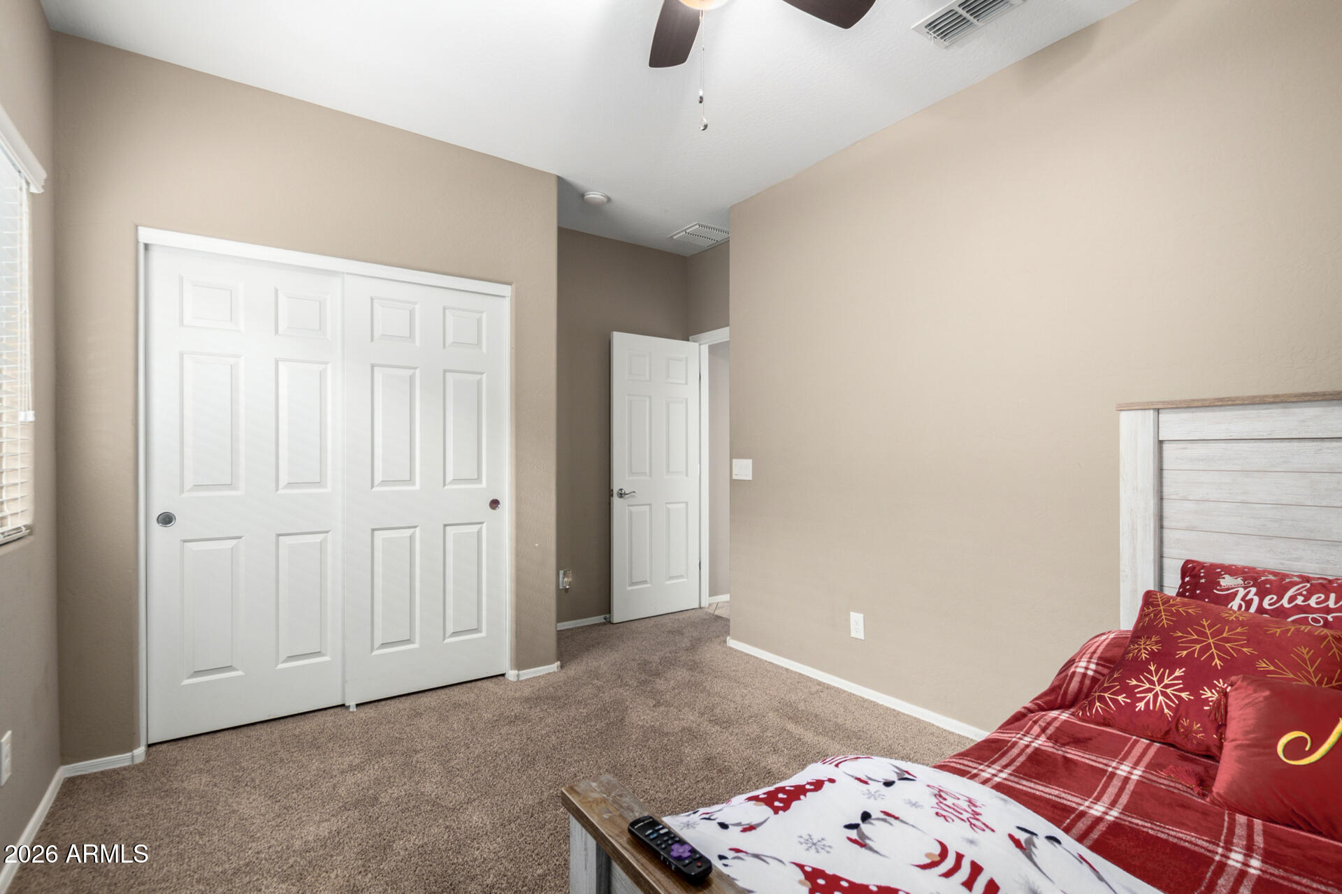 10816 West Nosean Road Peoria, AZ 85383 - Photo 24 of 42 a bedroom with a bed and a chandelier