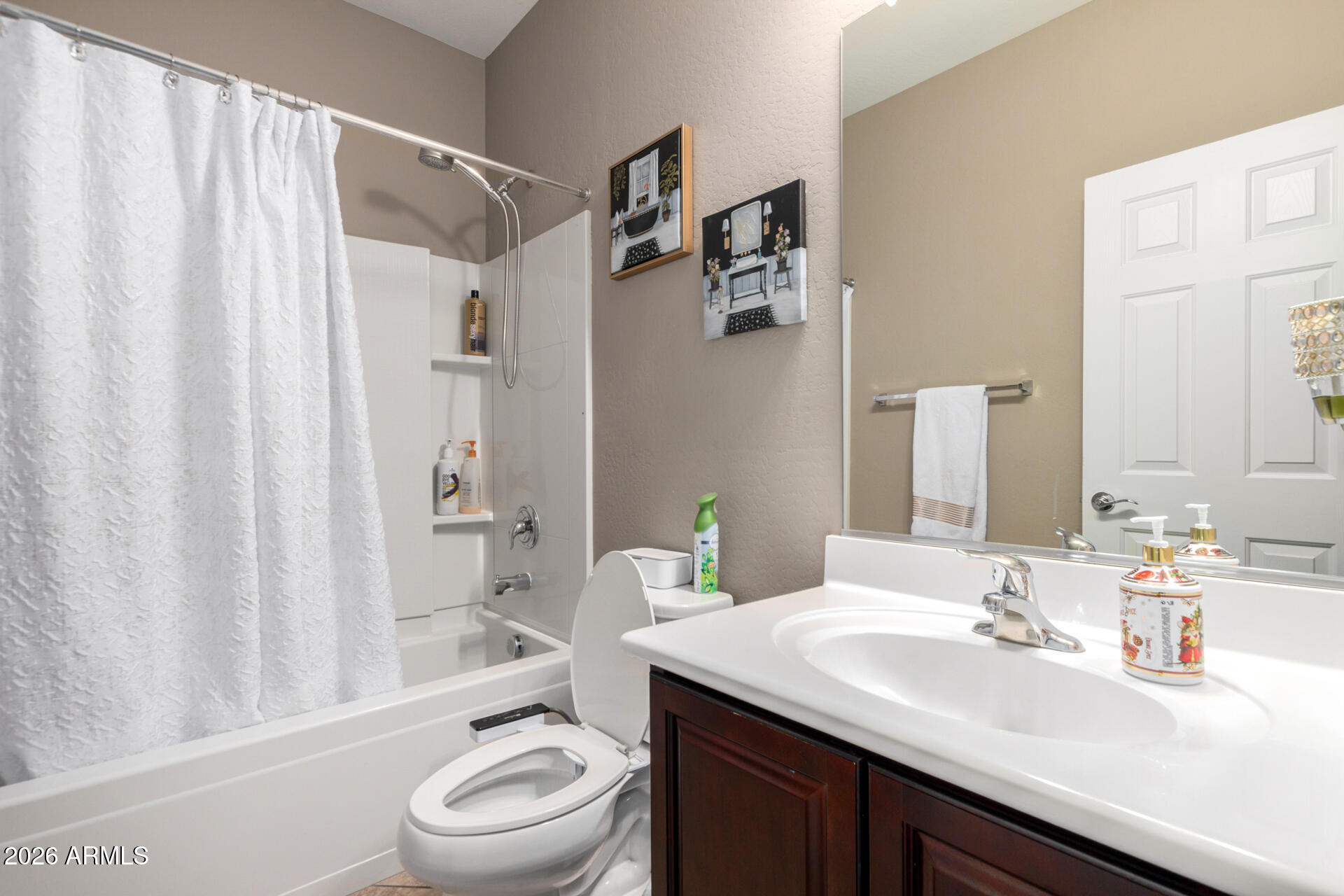 10816 West Nosean Road Peoria, AZ 85383 - Photo 25 of 42 a bathroom with a sink a toilet and shower curtain