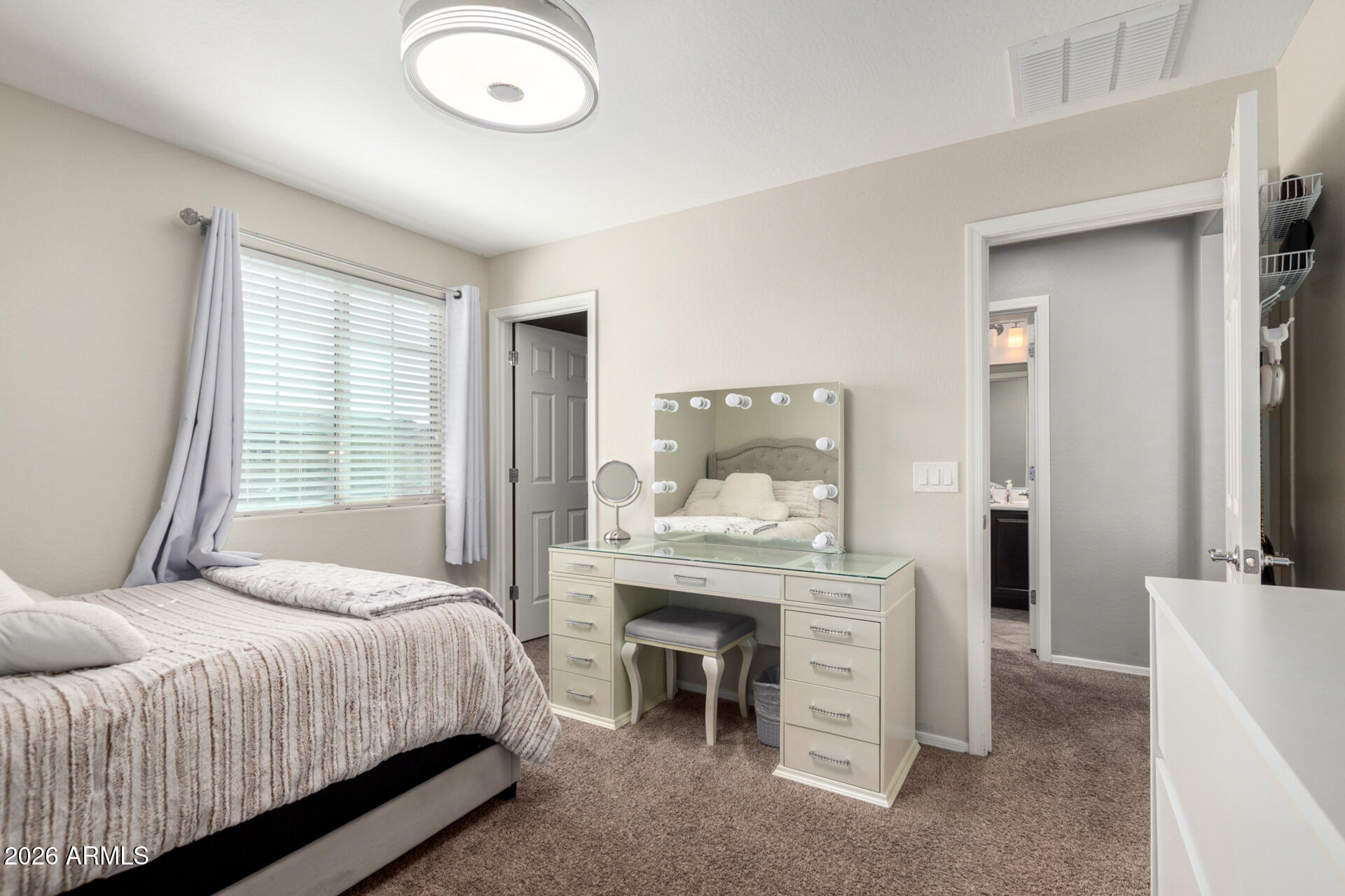 10816 West Nosean Road Peoria, AZ 85383 - Photo 27 of 42 a bedroom with a bed and a mirror