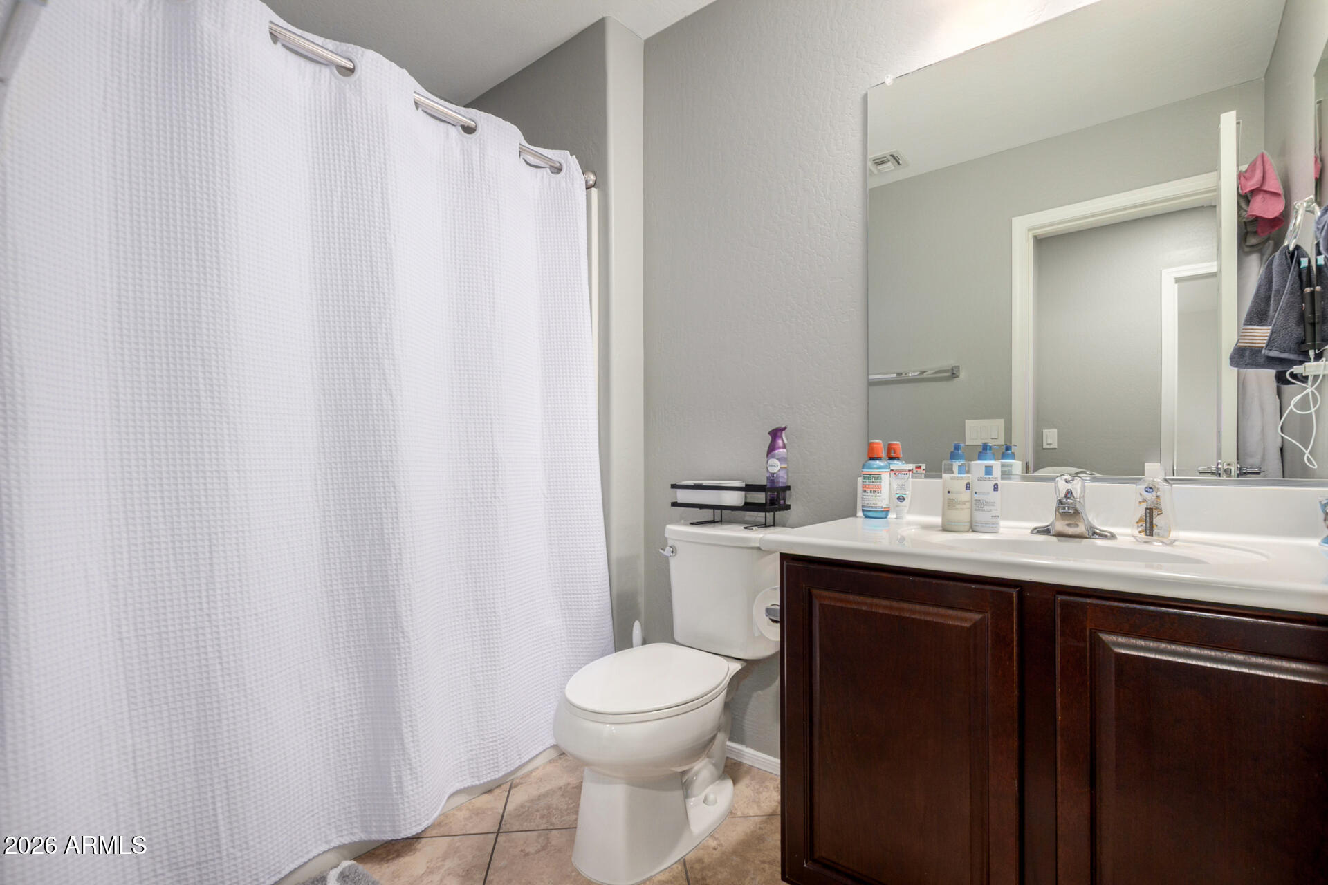 10816 West Nosean Road Peoria, AZ 85383 - Photo 28 of 42 a bathroom with a granite countertop sink toilet and a mirror