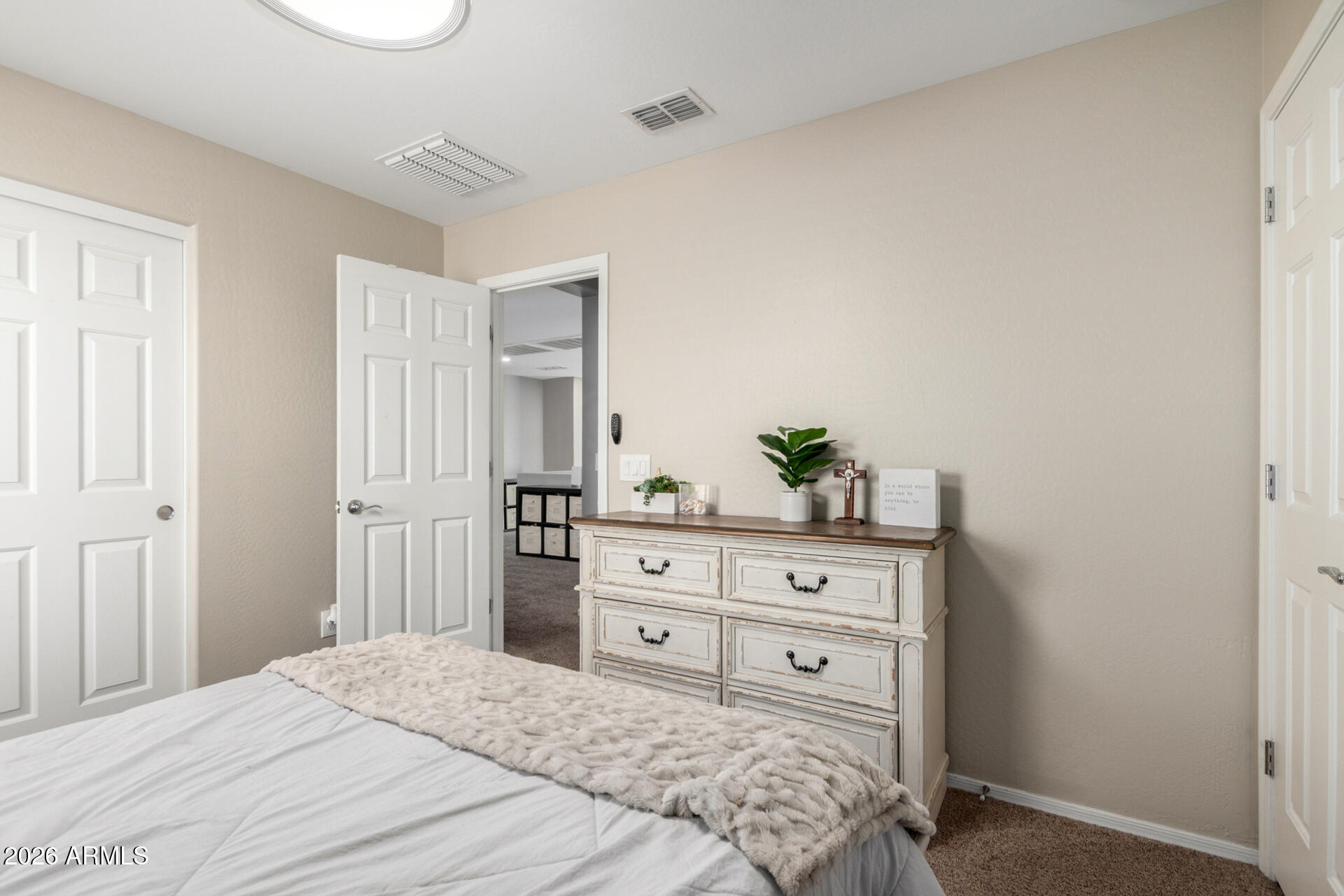 10816 West Nosean Road Peoria, AZ 85383 - Photo 30 of 42 a bedroom with a bed and a dresser