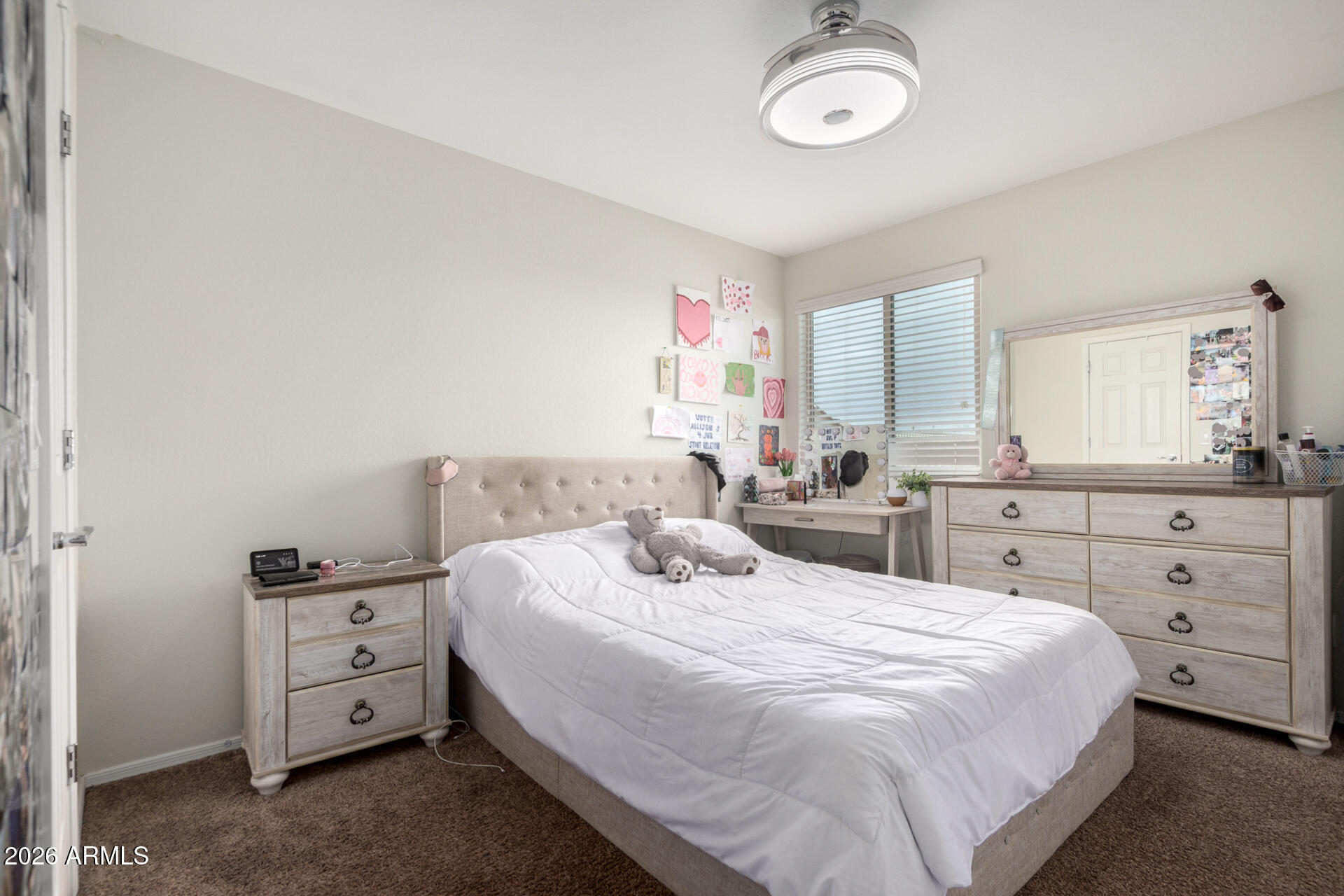 10816 West Nosean Road Peoria, AZ 85383 - Photo 31 of 42 a bedroom with a bed and a mirror