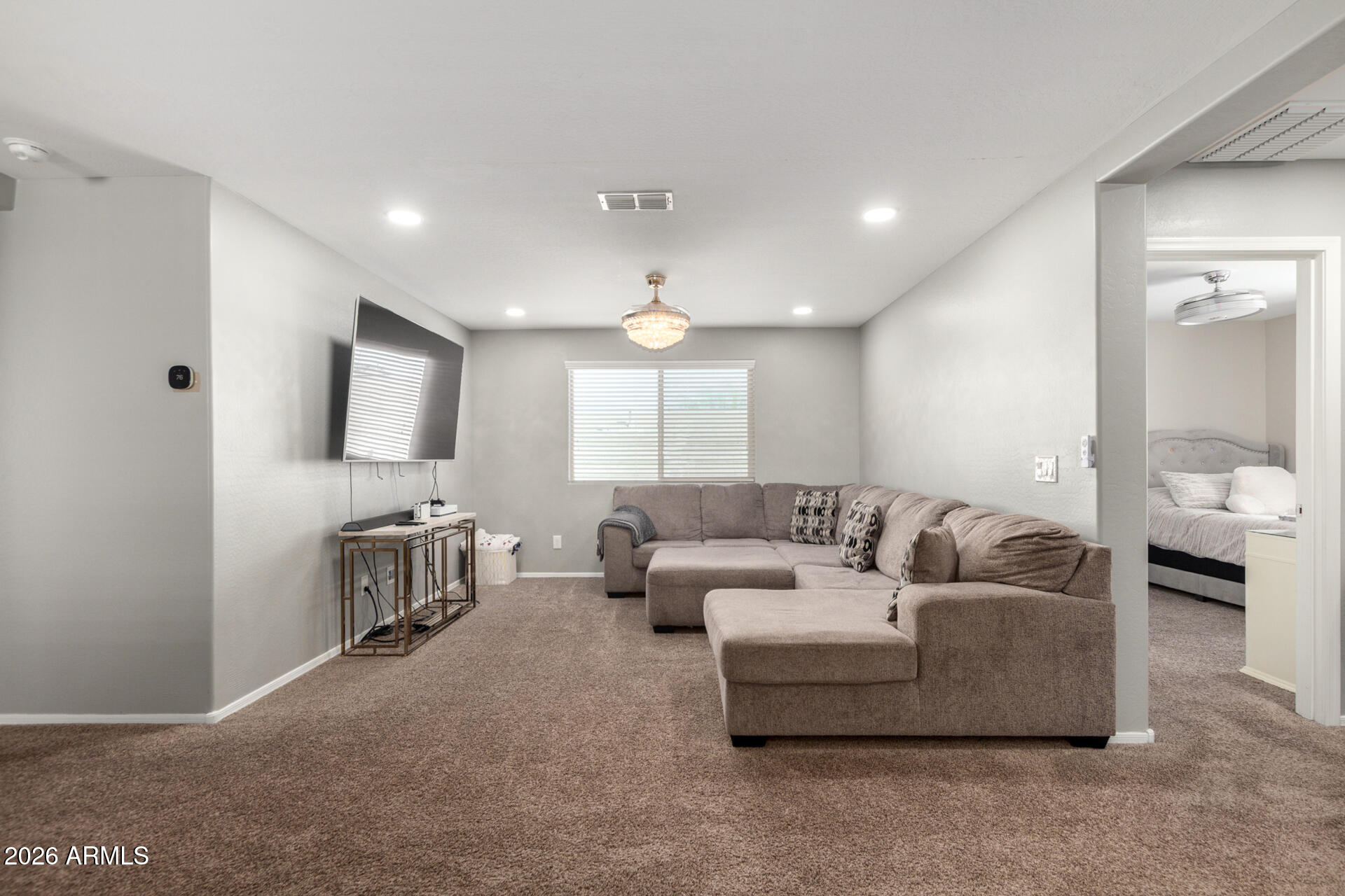 10816 West Nosean Road Peoria, AZ 85383 - Photo 34 of 42 a living room with furniture and a flat screen tv