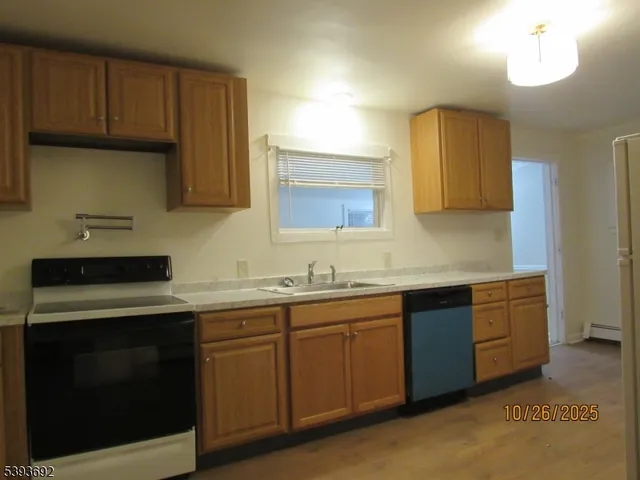 a kitchen with a sink a stove and cabinets