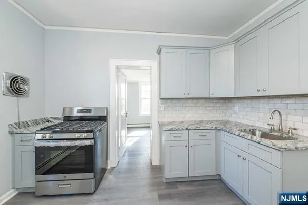 a kitchen with cabinets appliances and a sink