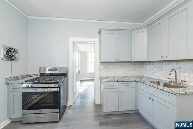 a kitchen with cabinets appliances and a sink