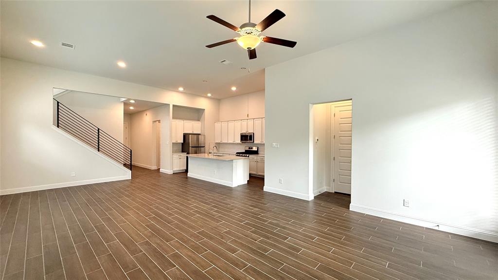 601 C-Bar Ranch Trail, Unit 27 Cedar Park, TX 78613 - Photo 7 of 29 Spacious living area featuring wood-finish tile flooring, recessed lighting, and a contemporary ceiling fan