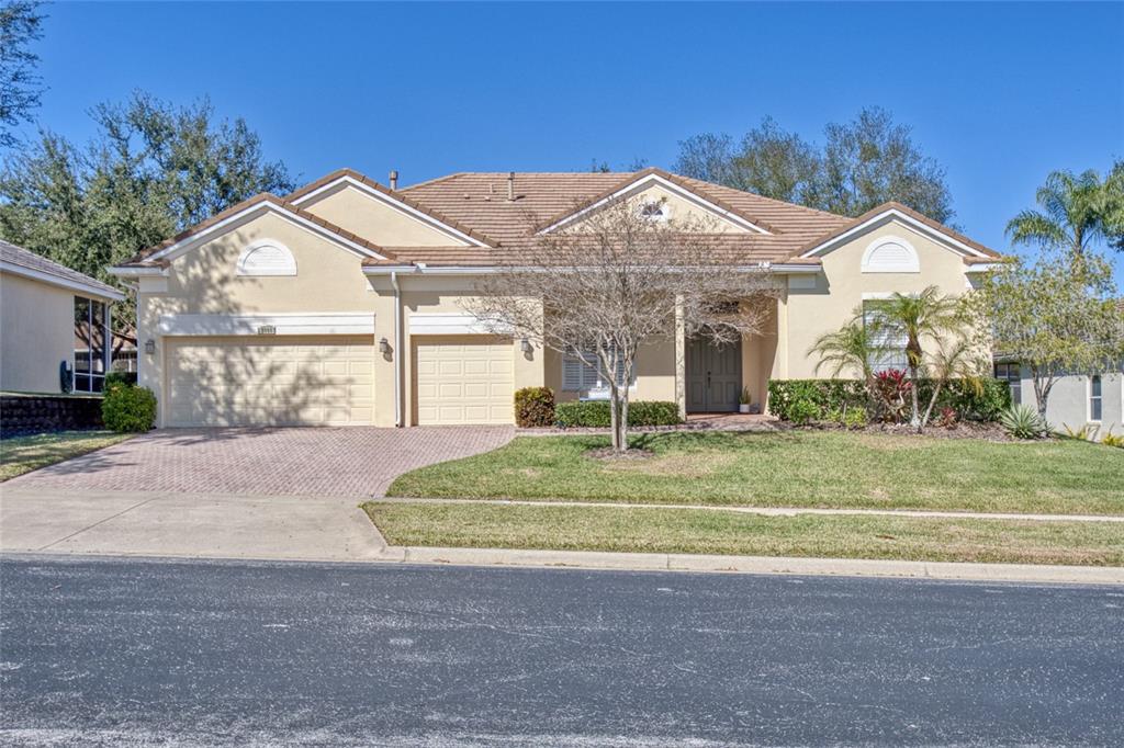 a front view of a house with a yard and garage