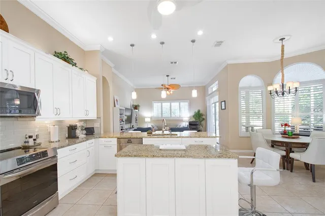 a kitchen with stainless steel appliances granite countertop a sink and a refrigerator