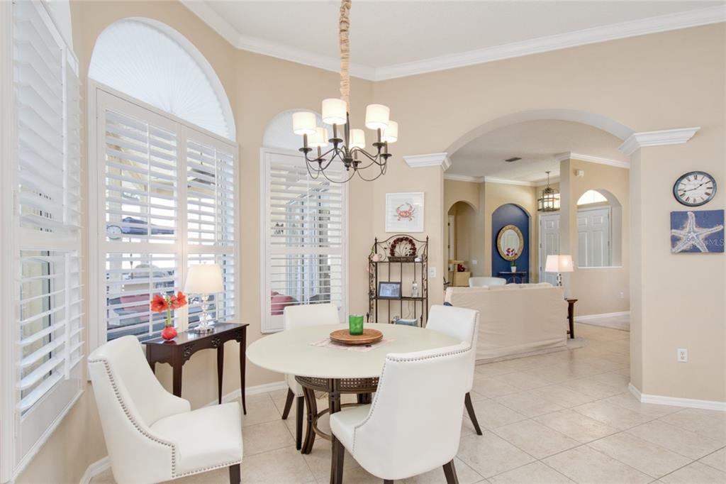 2808 Falcon Ridge Clermont, FL 34711 - Photo 14 of 65 a view of a dining room with furniture a chandelier and large windows
