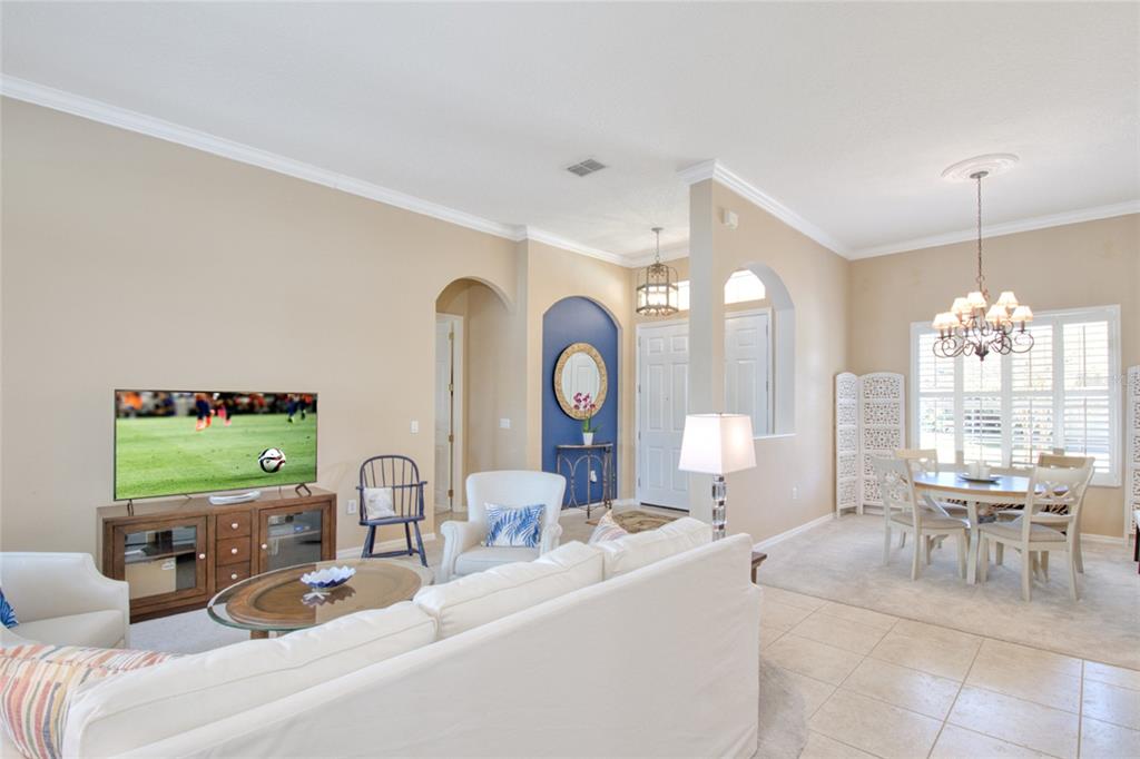 2808 Falcon Ridge Clermont, FL 34711 - Photo 15 of 65 a living room with furniture a large window and a clock