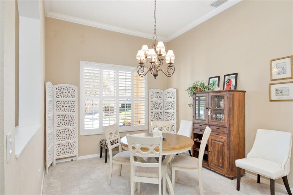 2808 Falcon Ridge Clermont, FL 34711 - Photo 2 of 65 a dining room with furniture a rug and a chandelier
