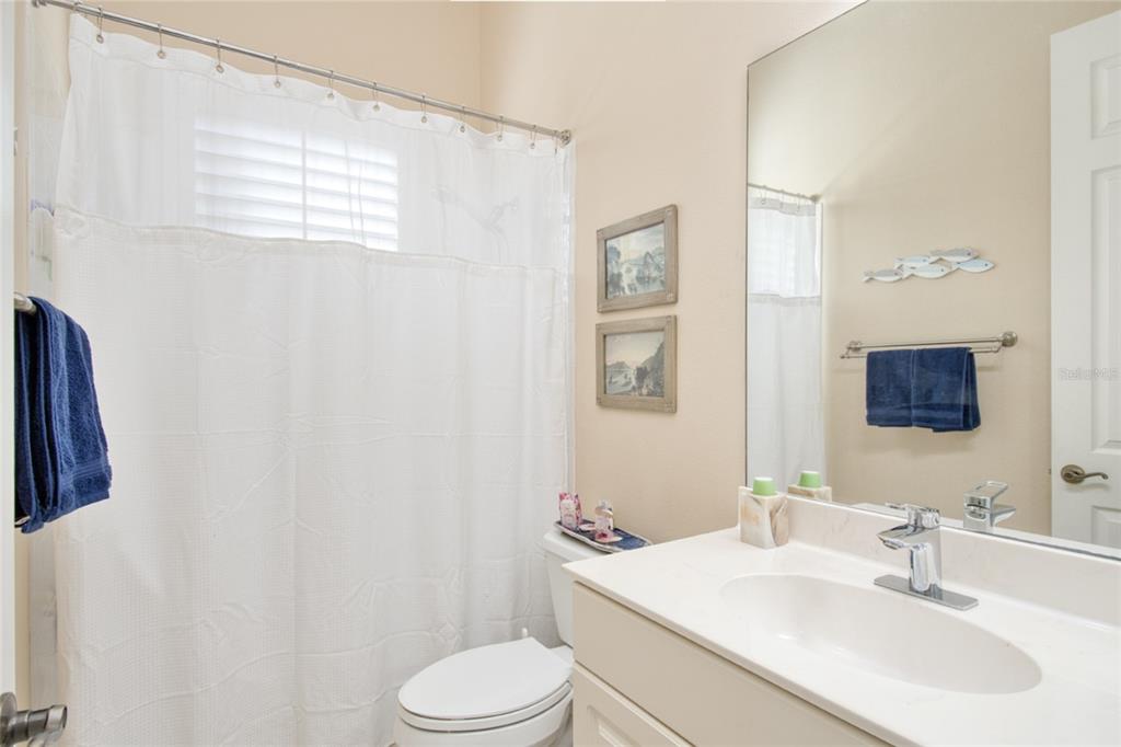 2808 Falcon Ridge Clermont, FL 34711 - Photo 22 of 65 a bathroom with a sink a toilet and mirror
