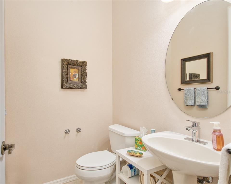 2808 Falcon Ridge Clermont, FL 34711 - Photo 23 of 65 a bathroom with a toilet a sink and mirror