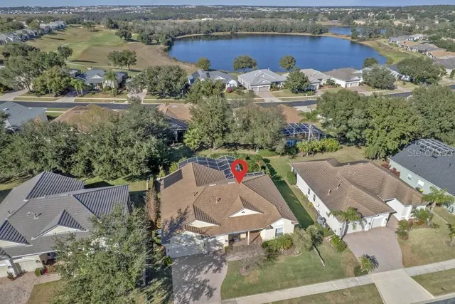 an aerial view of a house with yard swimming pool and outdoor seating