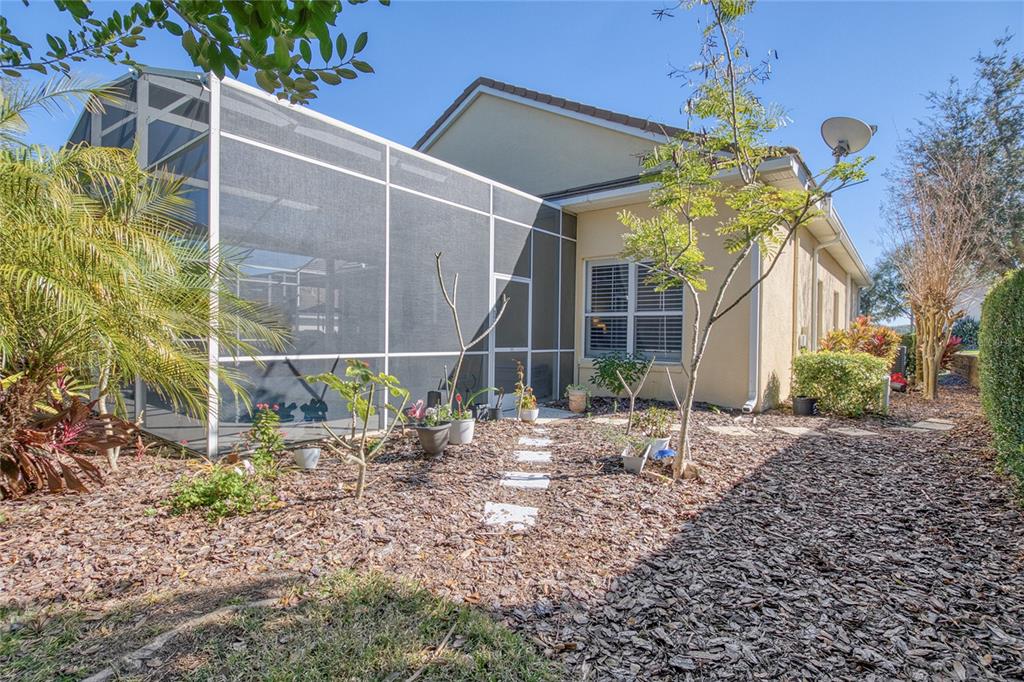 2808 Falcon Ridge Clermont, FL 34711 - Photo 33 of 65 a backyard of a house with plants and outdoor seating